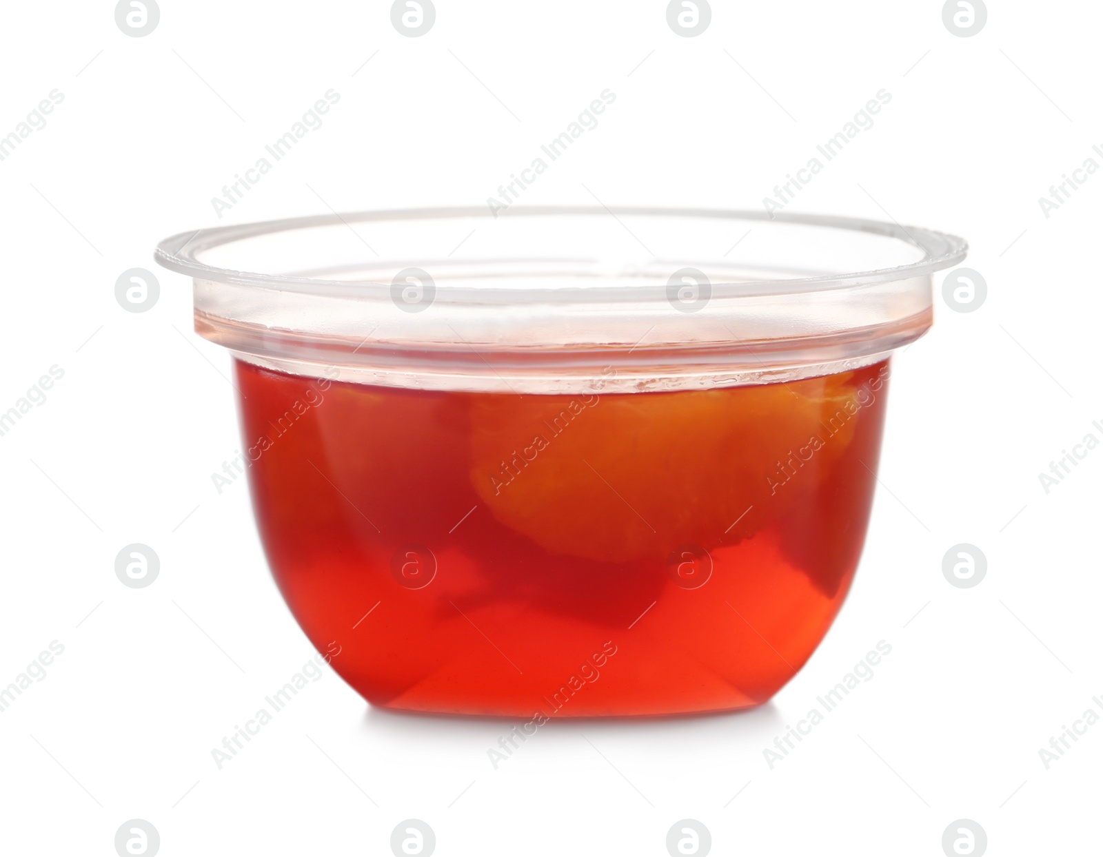 Photo of Tasty jelly dessert with slices of fruit in plastic cup on white background