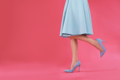 Photo of Woman in elegant shoes on pink background. Space for text