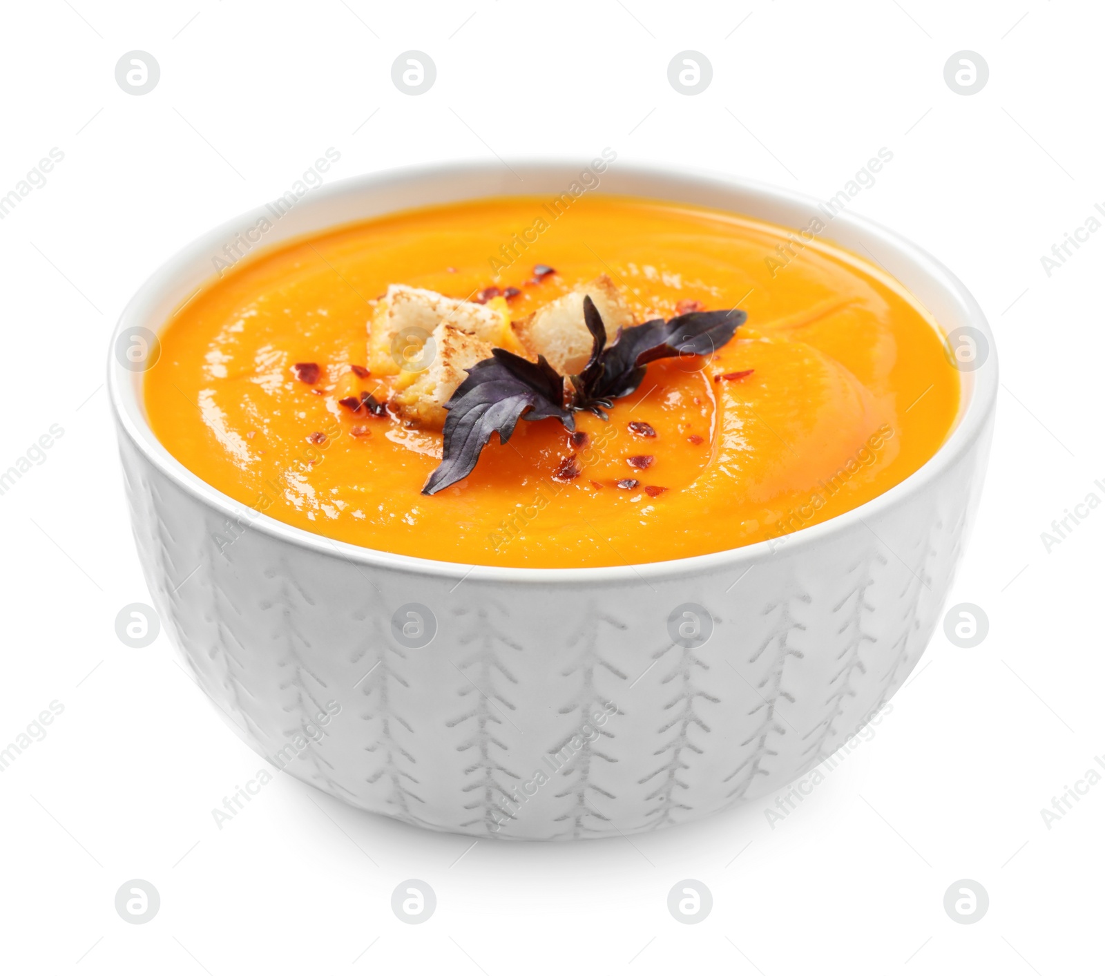 Image of Tasty creamy pumpkin soup in bowl on white background