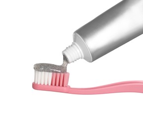Photo of Applying charcoal toothpaste on brush against white background