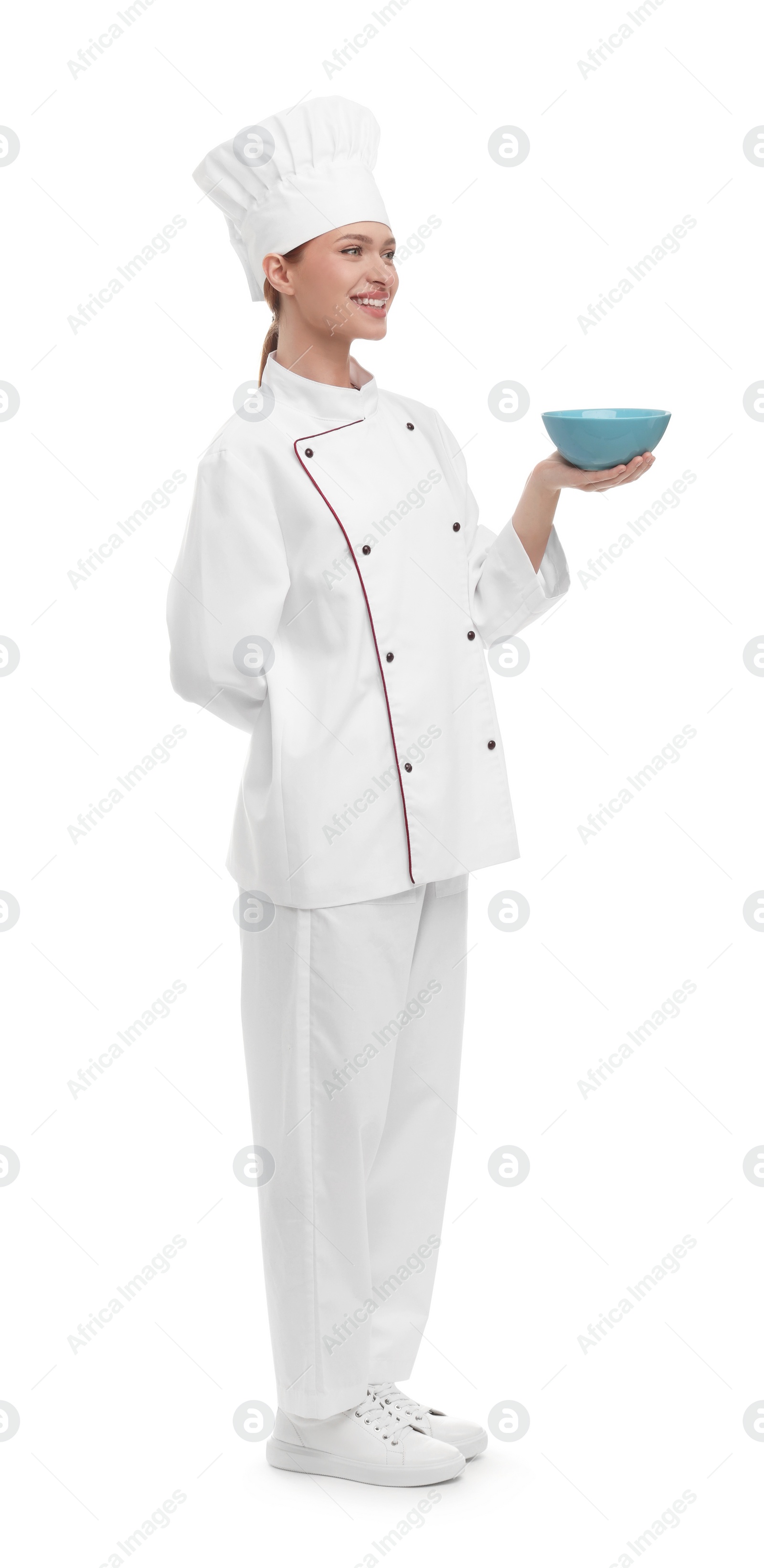 Photo of Happy woman chef in uniform holding bowl on white background