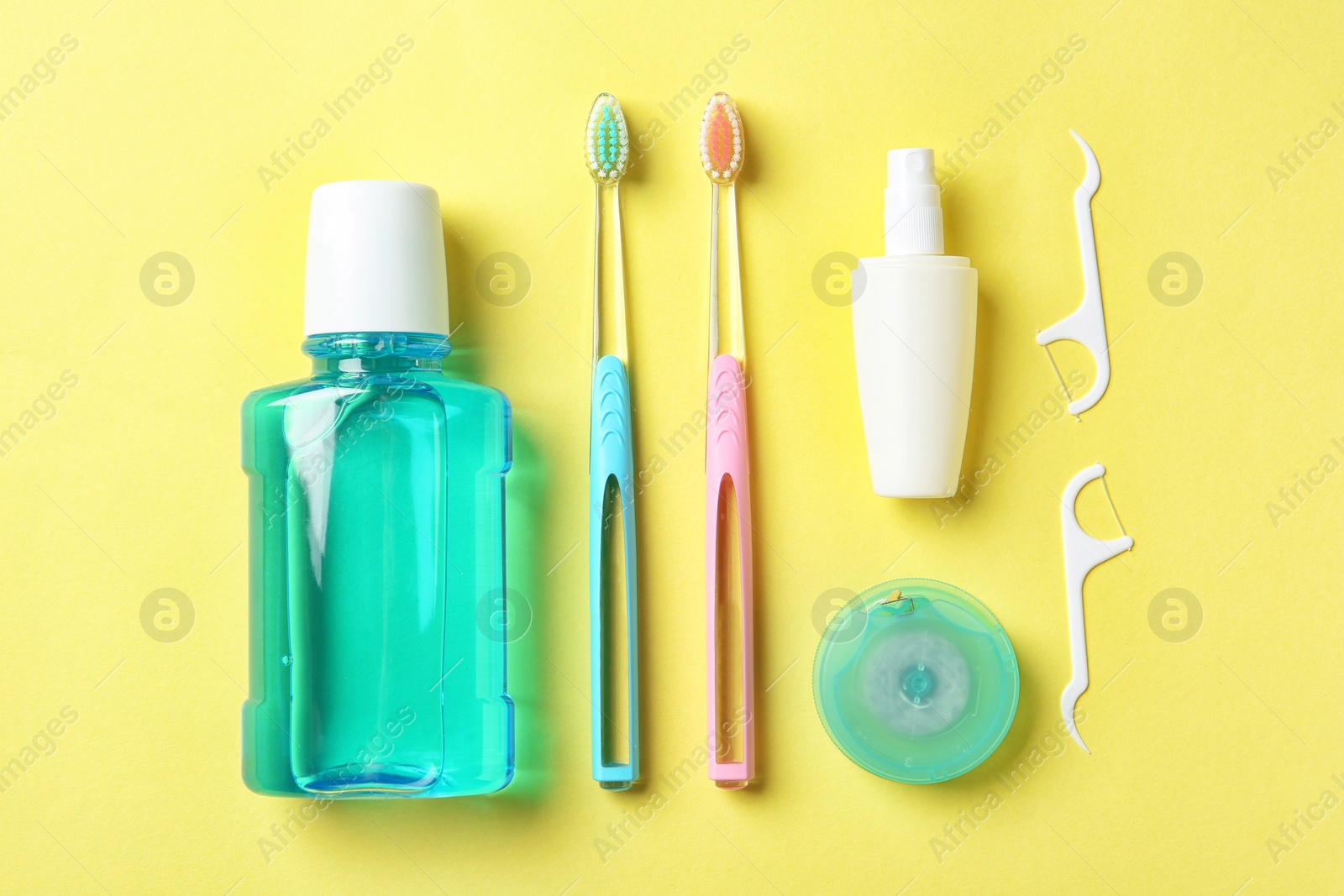 Photo of Flat lay composition with manual toothbrushes and oral hygiene products on color background