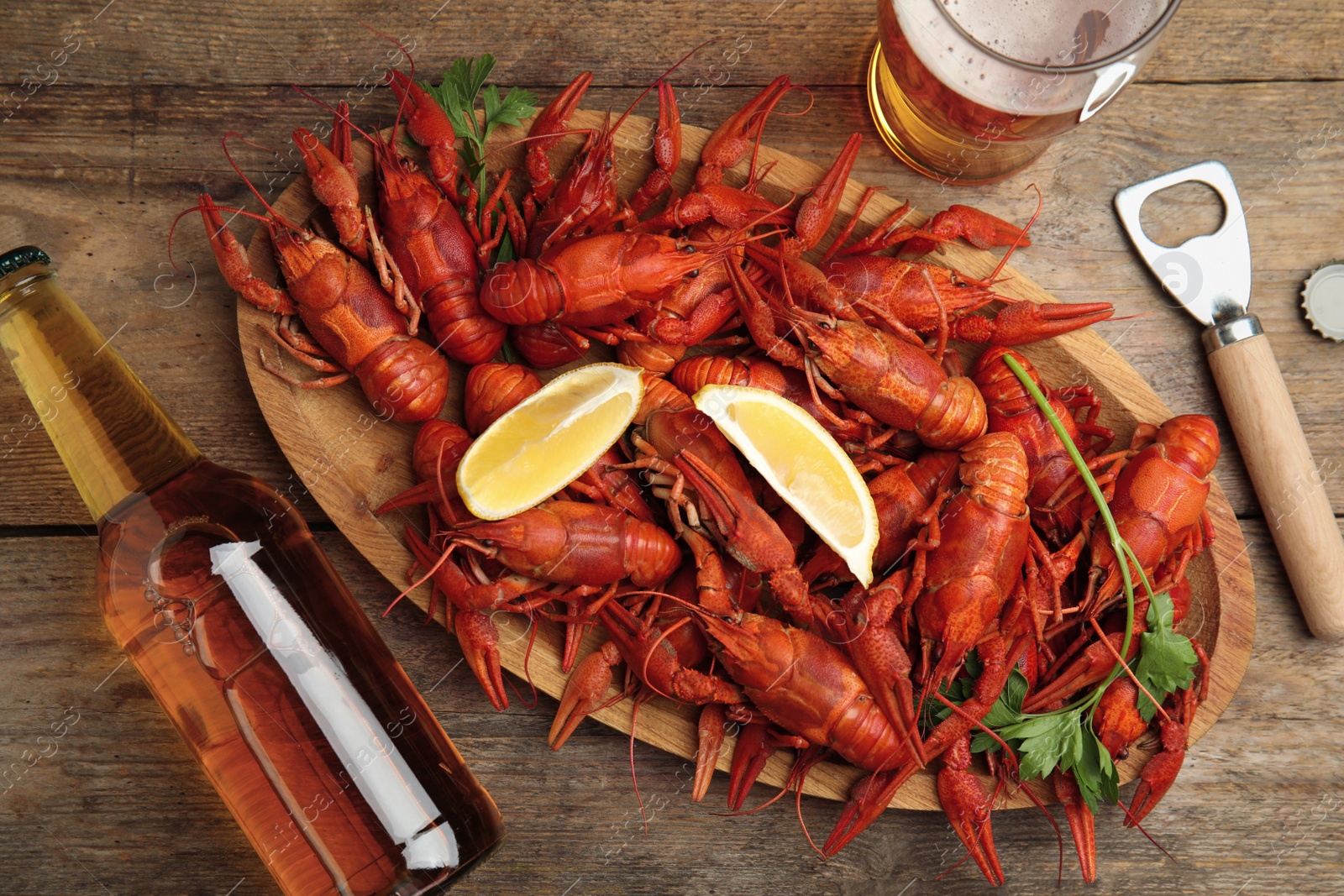 Photo of Flat lay composition with delicious red boiled crayfishes on wooden table