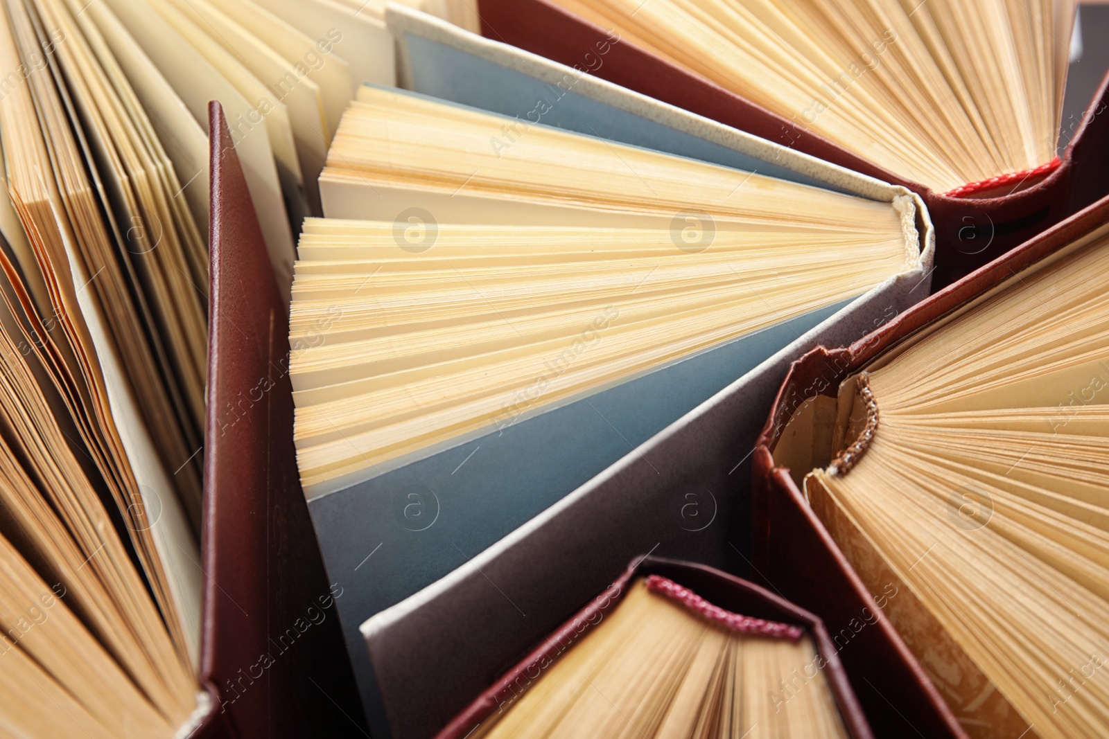 Photo of Many different hardcover books as background, closeup