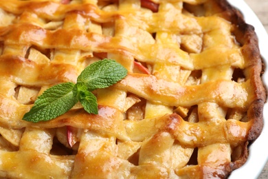 Photo of Fresh traditional apple pie with mint, closeup