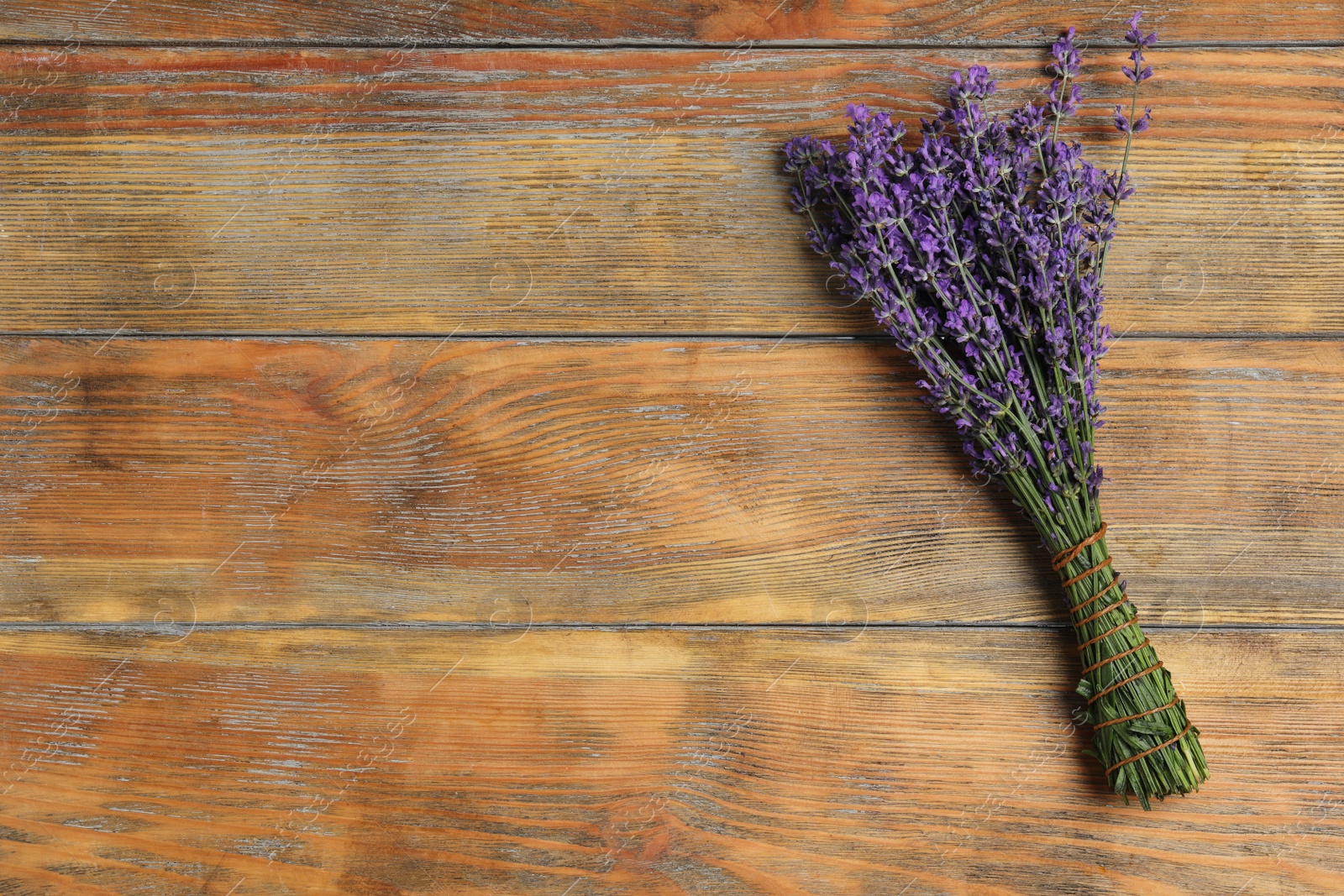 Photo of Beautiful lavender bouquet on wooden background, top view. Space for text