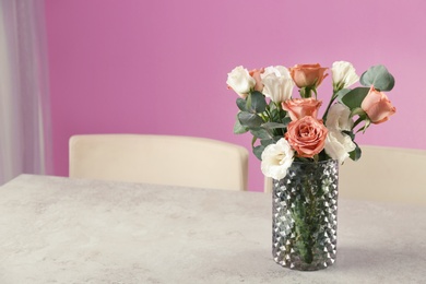 Photo of Vase with beautiful flowers as element of interior design on table in room. Space for text