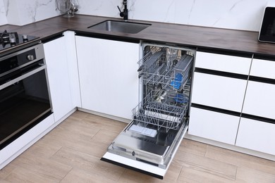 Built-in dishwasher with open door in kitchen