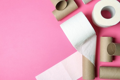 Flat lay composition with toilet paper and empty rolls on color background. Space for text