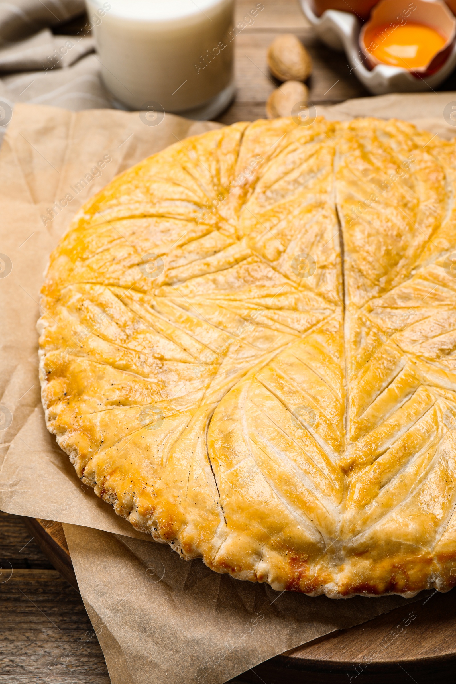 Photo of Traditional galette des rois on wooden table, closeup