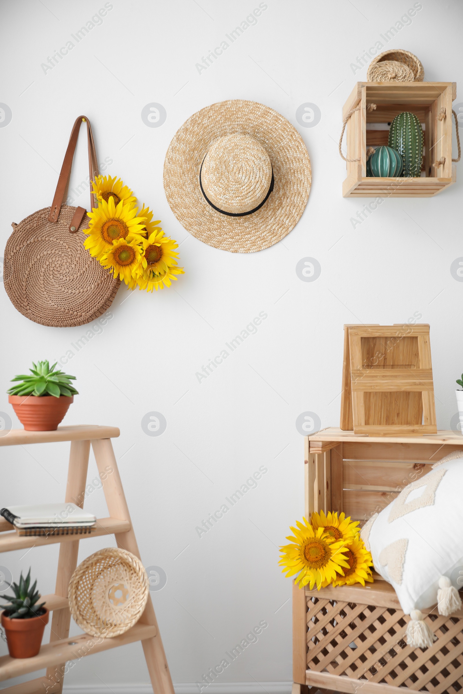 Photo of Bag with bouquet of beautiful sunflowers in stylish room interior