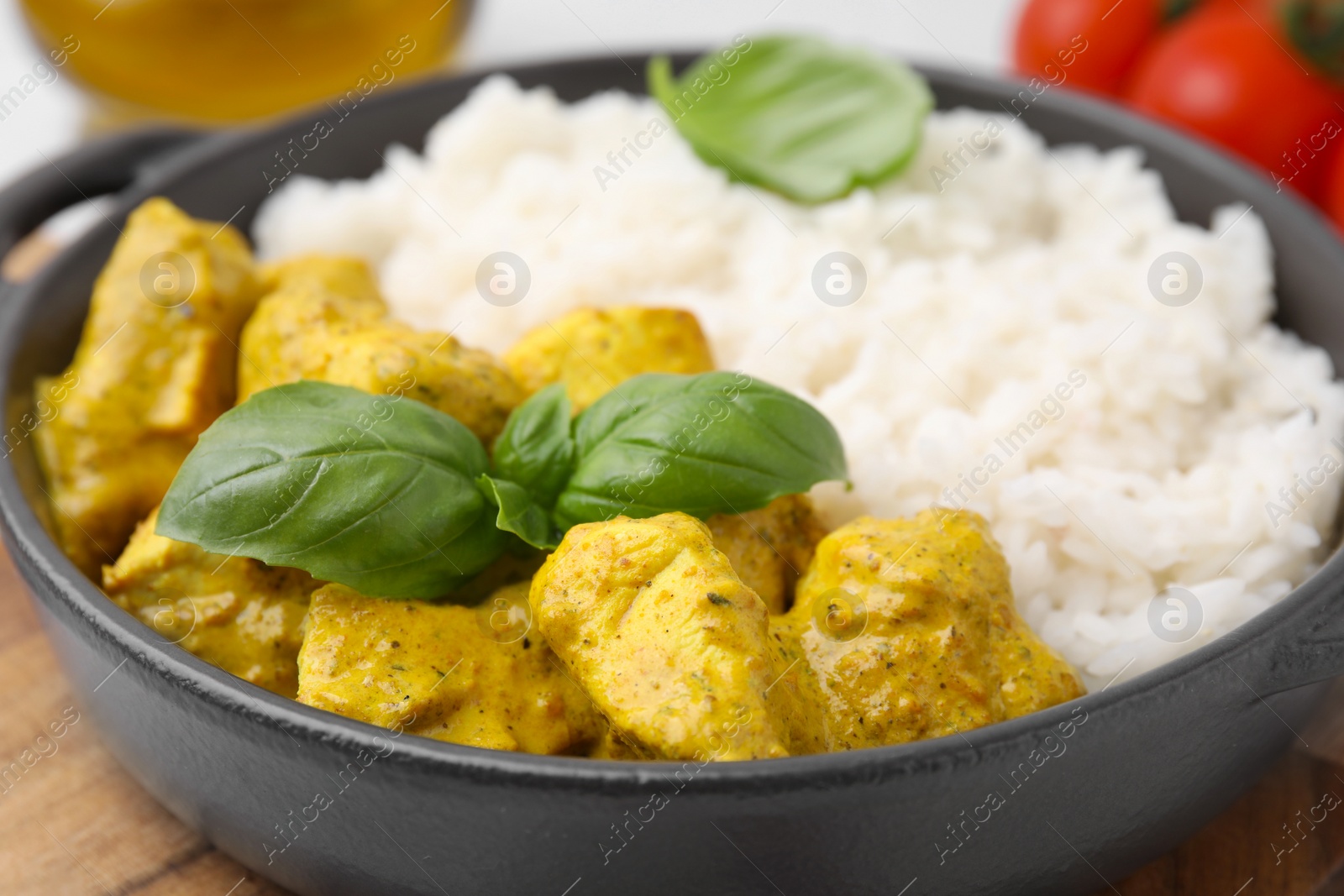 Photo of Delicious rice and chicken with curry sauce on table, closeup