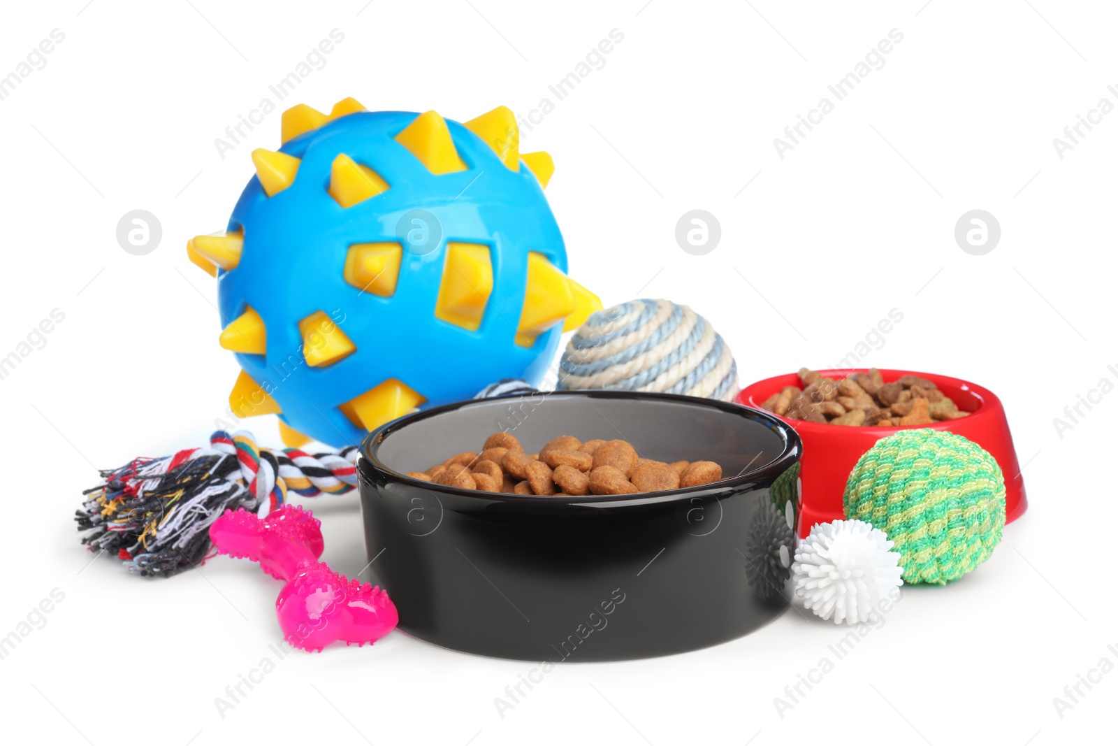 Photo of Feeding bowls and toys for pet on white background