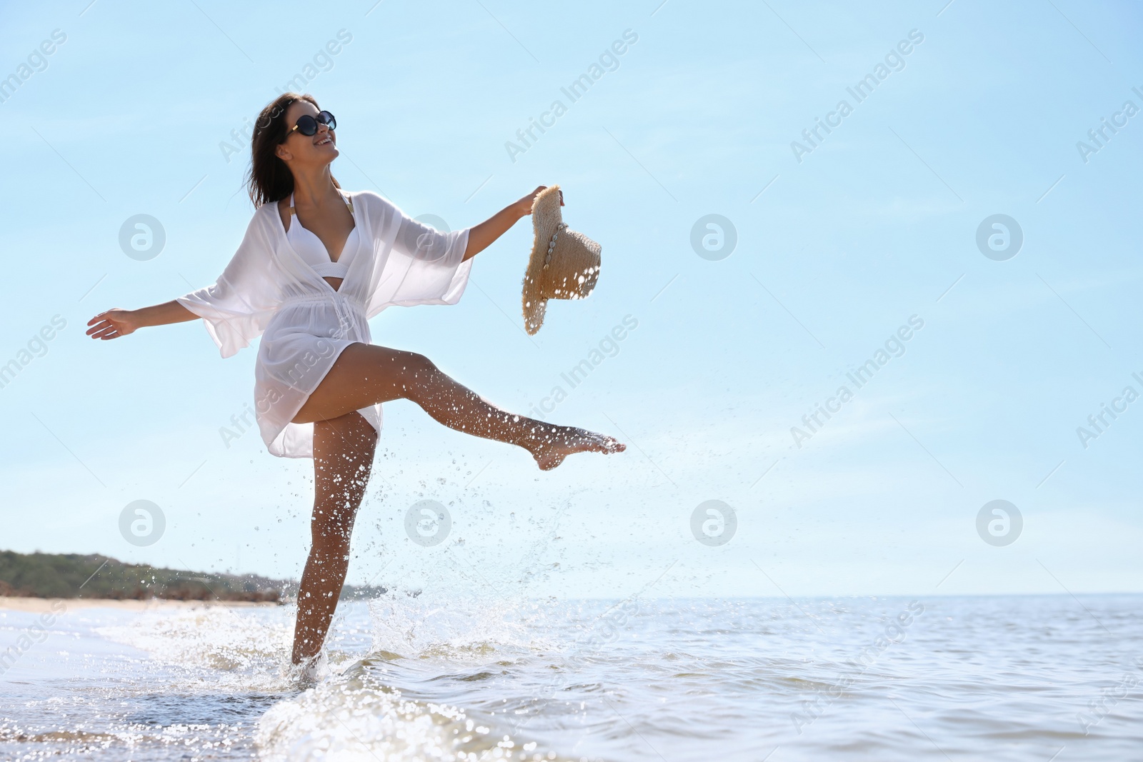 Photo of Young woman with beautiful body on beach. Space for text