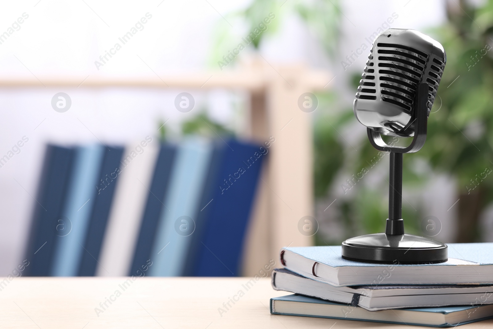 Photo of Retro microphone and notebooks on table indoors, space for text. Job interview