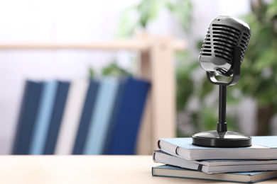 Retro microphone and notebooks on table indoors, space for text. Job interview