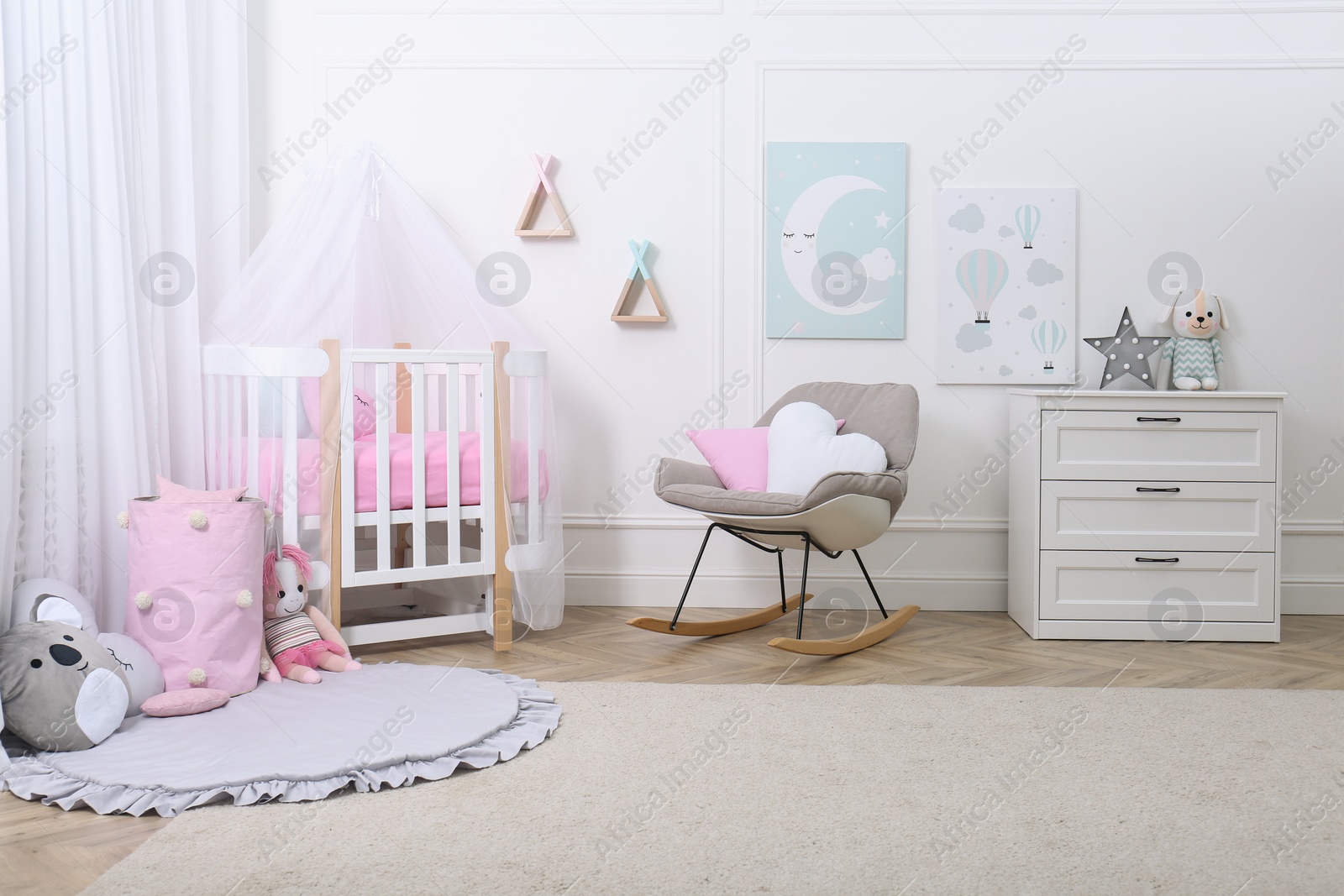 Photo of Baby room interior with toys and stylish furniture