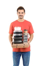 Young courier with pizza boxes, containers and drinks on white background. Food delivery service