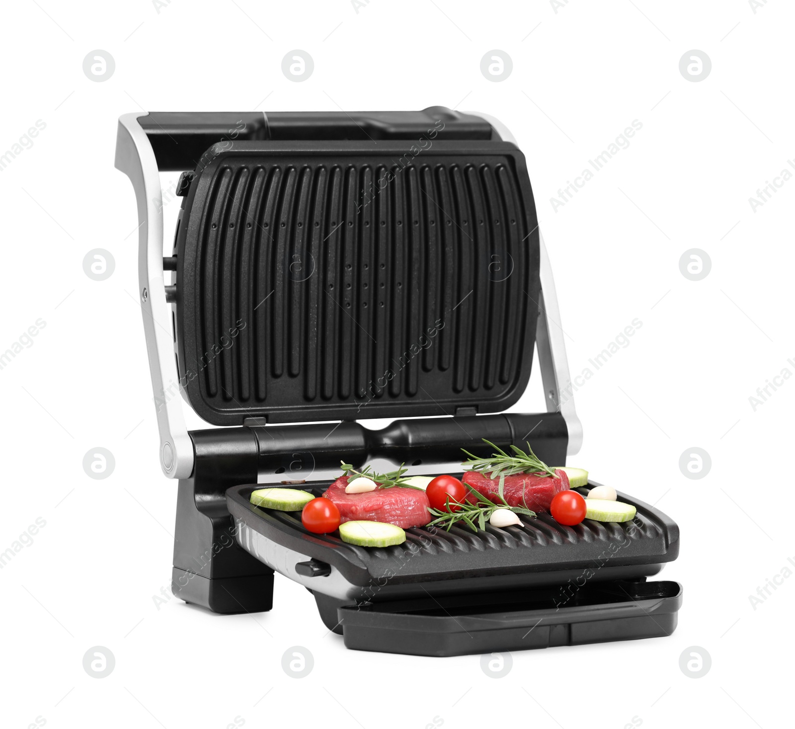 Photo of Electric grill with raw meat, rosemary and vegetables isolated on white