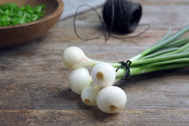 Photo of Fresh green onion on wooden table