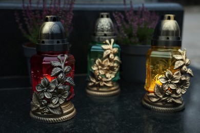 Photo of Grave lights on granite surface at cemetery