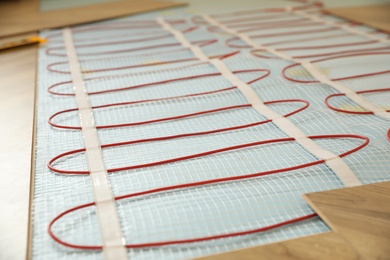 Photo of Installation of electric underfloor heating system indoors, closeup