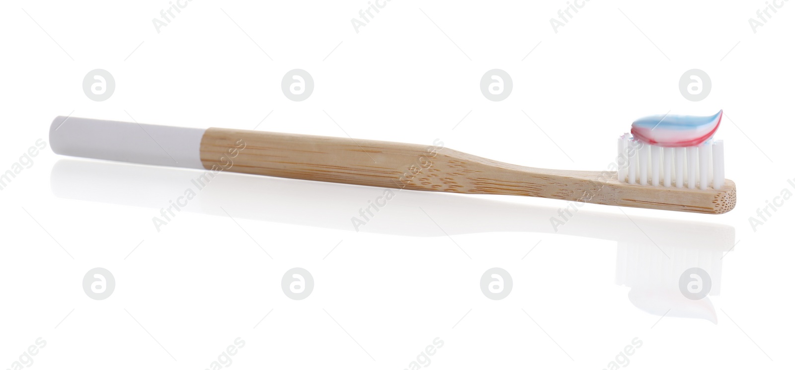 Photo of Wooden brush with toothpaste isolated on white
