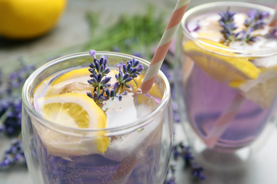 Photo of Fresh delicious lemonade with lavender on grey table, closeup