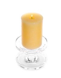 Burning yellow wax candle isolated on white