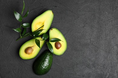 Photo of Fresh yummy avocado pieces on grey table