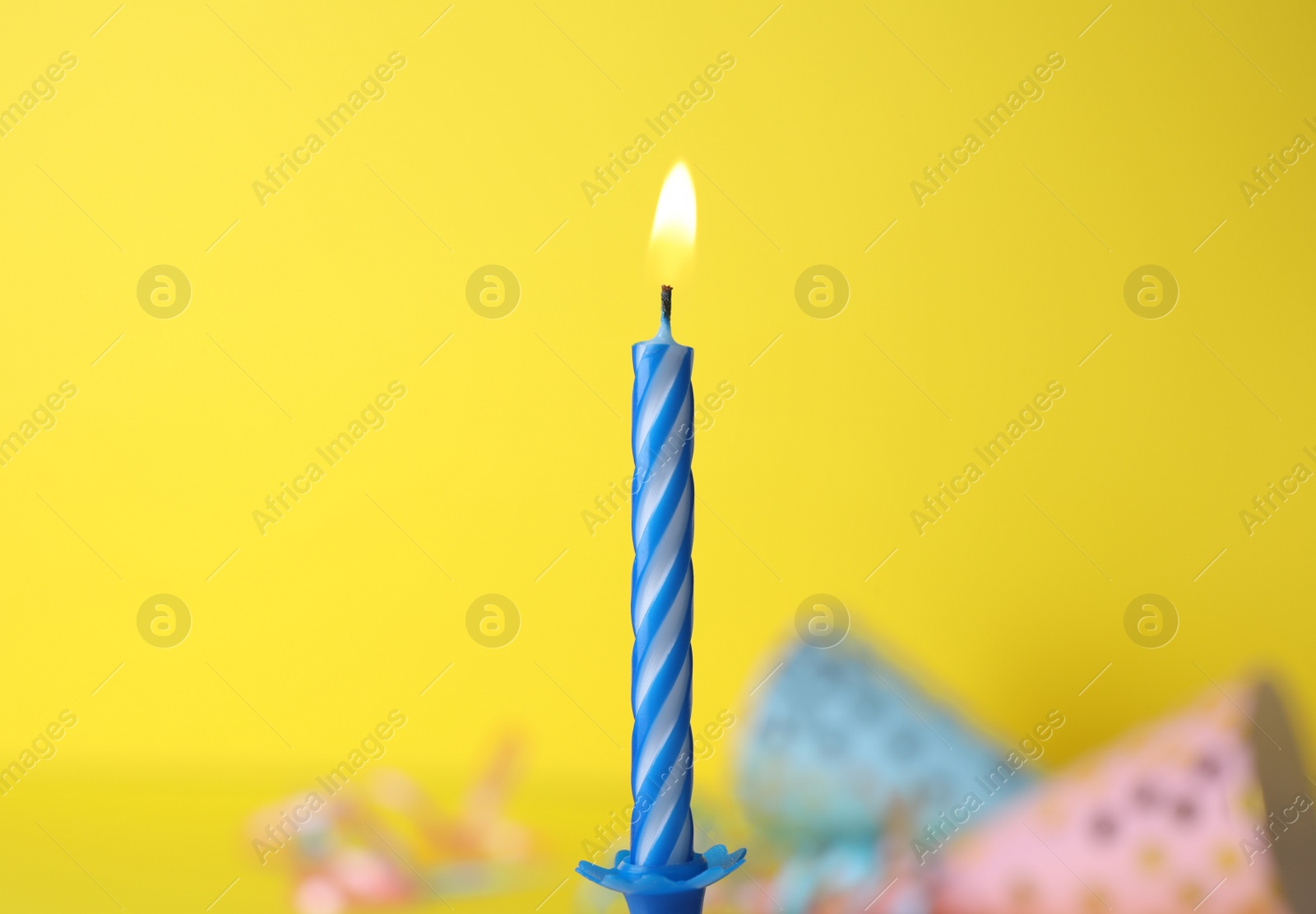 Photo of Burning birthday cake candle on color background. Space for text