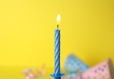 Burning birthday cake candle on color background. Space for text