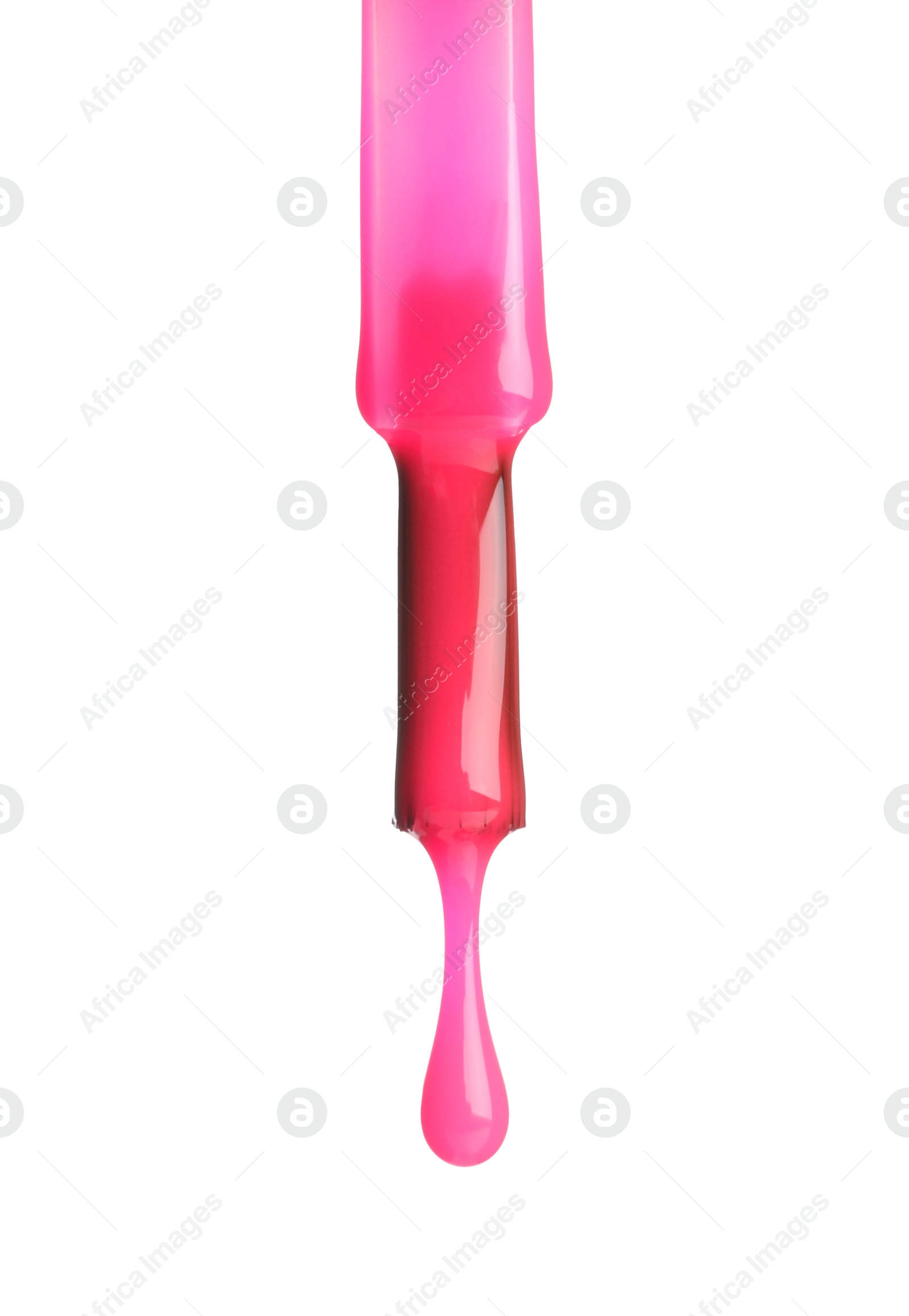 Photo of Pink nail polish dripping from brush isolated on white