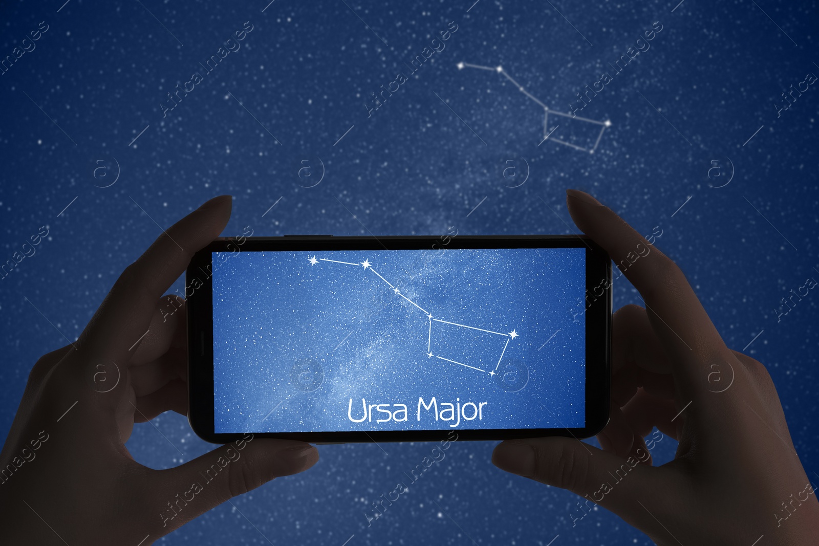 Image of Woman using stargazing app on her phone at night, closeup. Identified stick figure pattern of Great Bear (Ursa Major) constellation on device screen