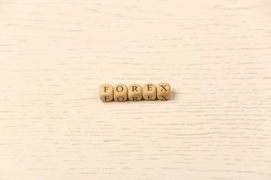 Photo of Word Forex with cubes on white wooden table