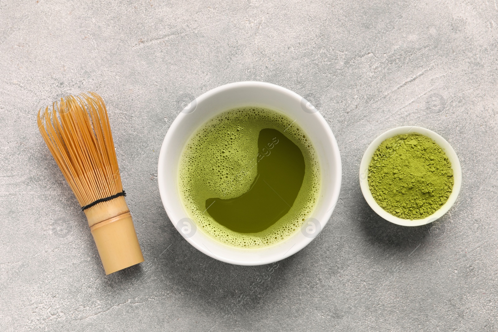 Photo of Flat lay composition with matcha tea on light gray textured table