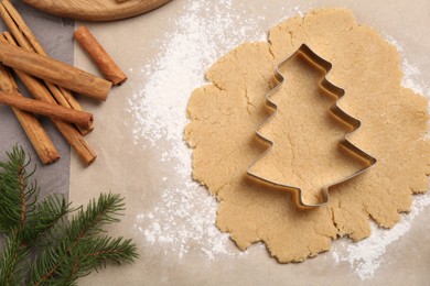 Making Christmas cookies. Flat lay composition with ingredients and raw dough on grey table