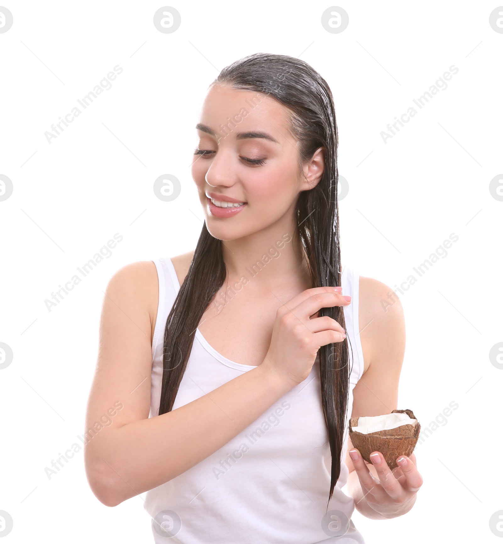 Photo of Young woman applying coconut oil onto hair against white background