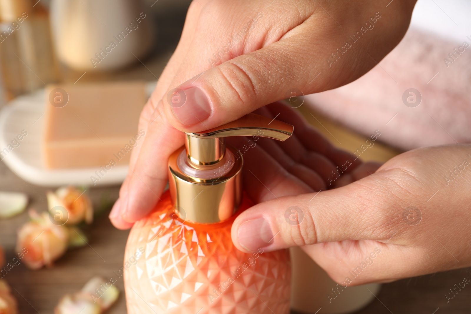 Photo of Woman using liquid soap dispenser, closeup view