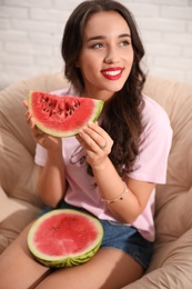 Beautiful young woman with watermelon at home