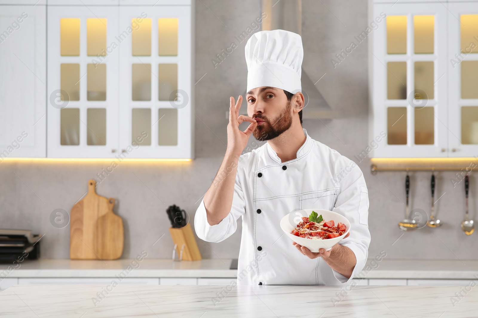 Photo of Professional chef presenting delicious dish in kitchen