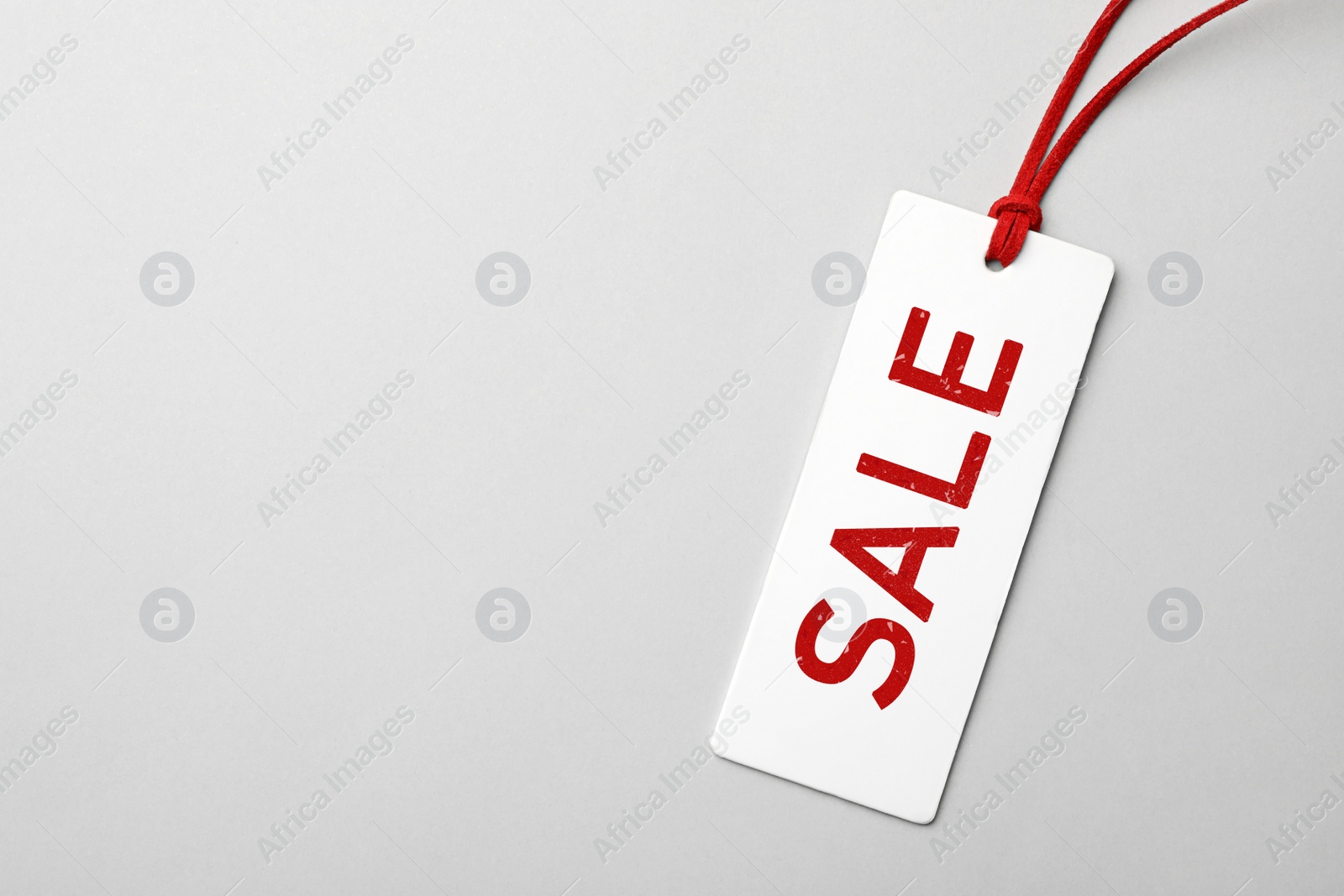 Image of Top view of tag with inscription SALE on light background, space for text. Black Friday 