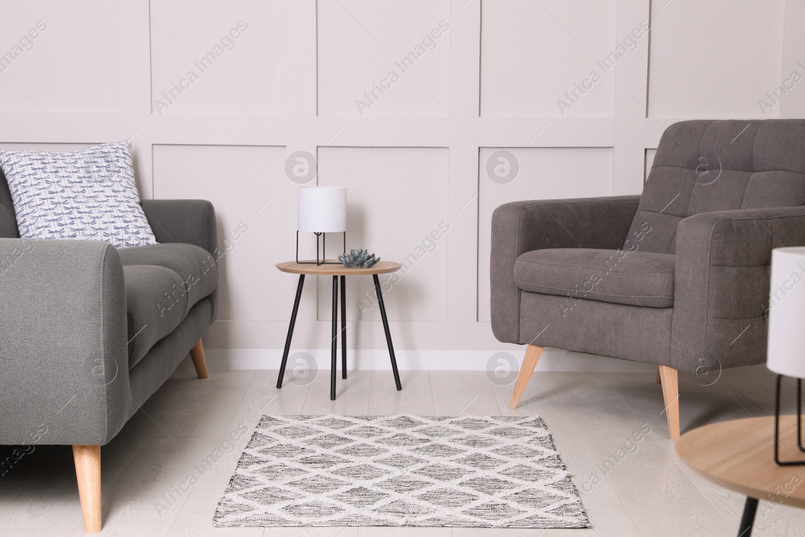 Photo of Stylish living room interior with grey rug and comfortable furniture