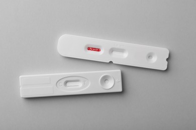 Photo of Two disposable express tests on light grey background, top view