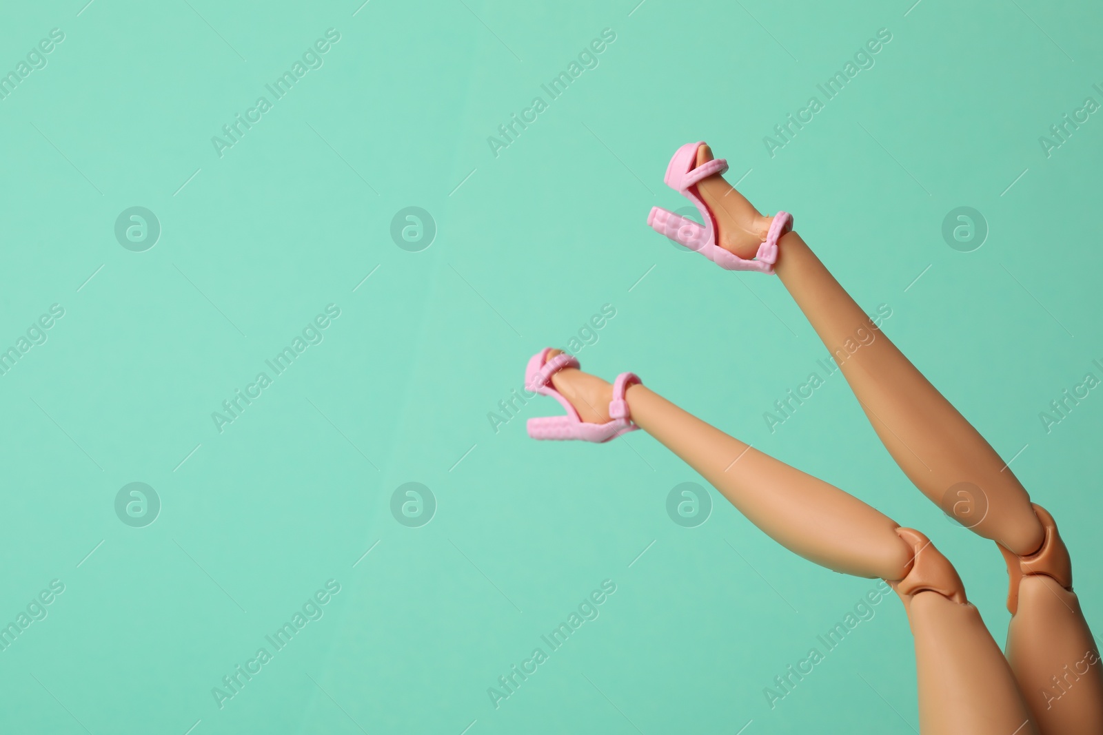 Photo of Mykolaiv, Ukraine - September 2, 2023: Barbie doll wearing beautiful heels on turquoise background, closeup with space for text