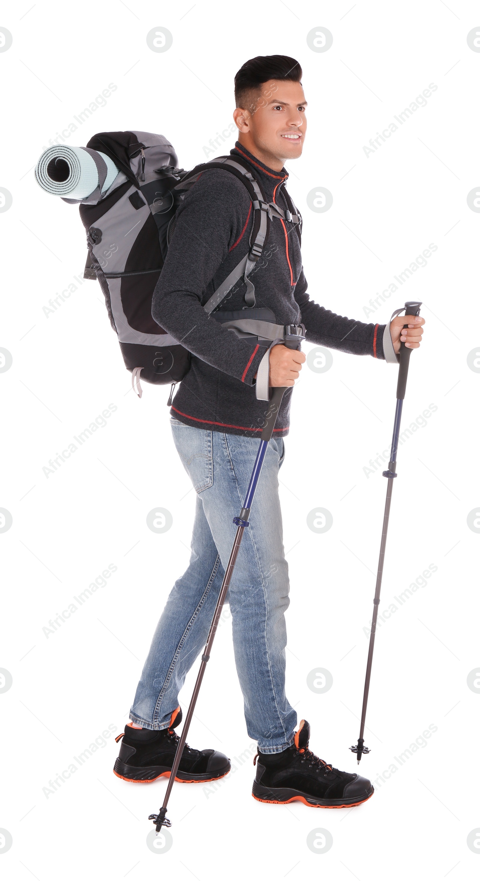 Photo of Male hiker with backpack and trekking poles on white background