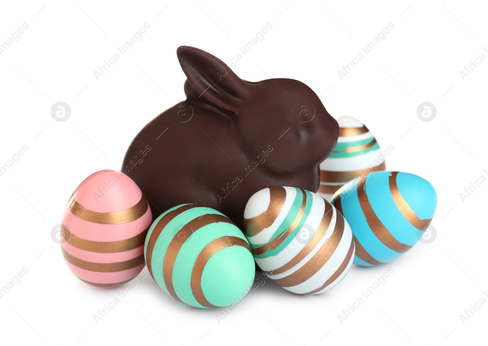 Photo of Chocolate Easter bunny and eggs on white background