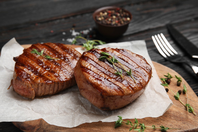 Photo of Delicious grilled beef medallions served on table, closeup