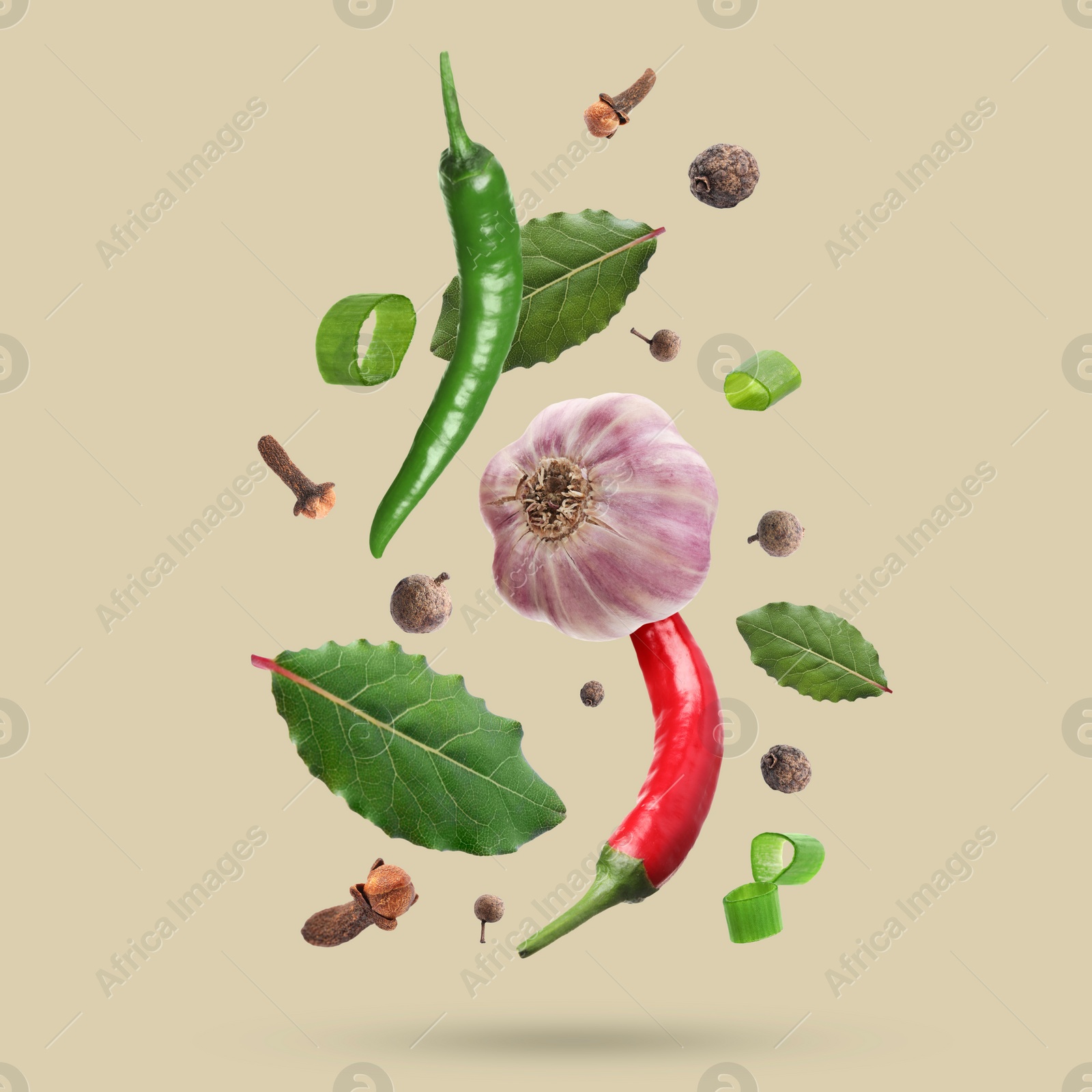 Image of Different spices falling on dark beige background