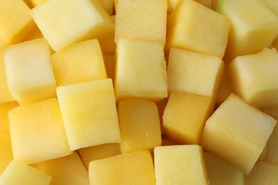 Many delicious mango cubes as background, closeup